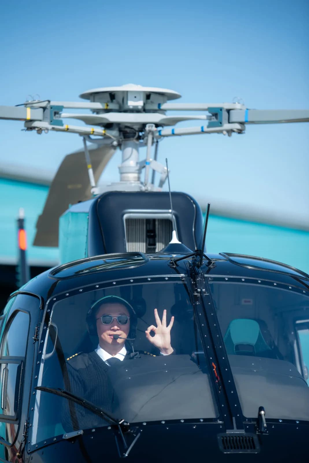 Pilot signaling all-clear from the helicopter cockpit
